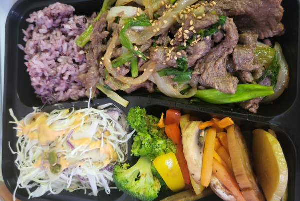 Bulgogi Korean lunch box with purple rice, vegetables, and salad